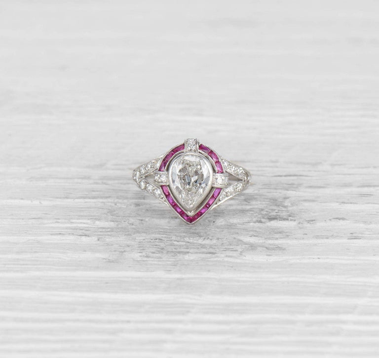 1.00 CARAT ART DECO PEAR DIAMOND AND RUBY ENGAGEMENT RING