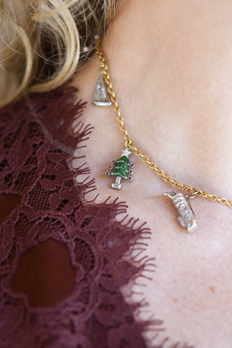 Antique Art Deco holiday-themed multi-gem platinum and 18K gold charm necklace with figural charms, circa 1920 close up - on a model