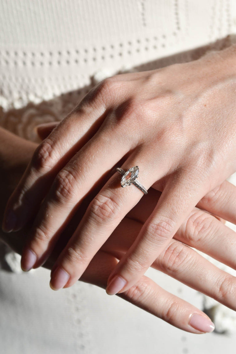 Art Deco Moval Shaped Diamond & Knife Edge Vintage Engagement Ring on a hand