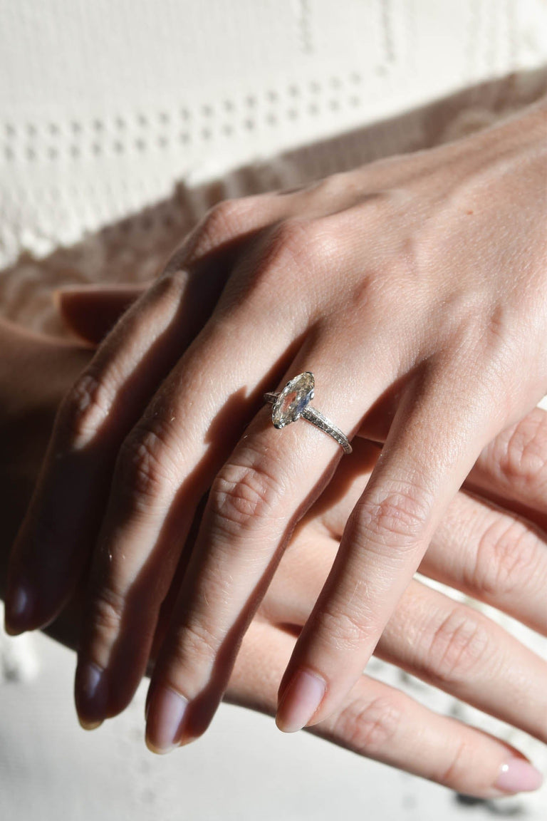 Art Deco Moval Shaped Diamond & Knife Edge Vintage Engagement Ring on a hand 3