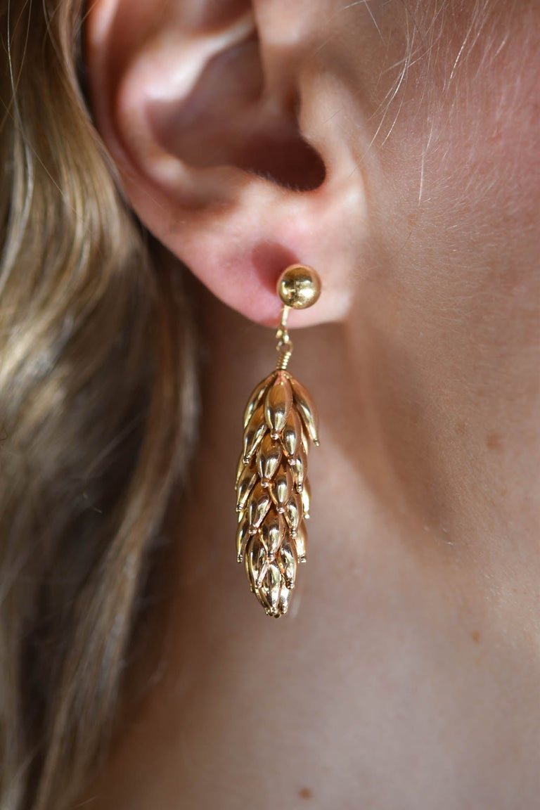 Mid-century 14K yellow gold articulated leaf earrings, circa 1950s - on a model