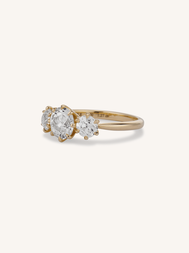 Strela 1.27 old European cut three-stone engagement ring in 18k yellow gold - on a hand - 3/4