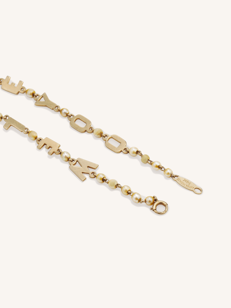 Vintage Lucien Piccard 14K gold and seed pearl “We Love You” bracelet, mid-century design circa 1950s - close up