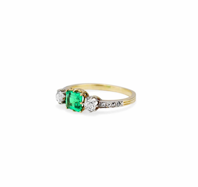 Late Edwardian .71 Carat Colombian Emerald-Cut Emerald and Diamond Three-Stone Ring
