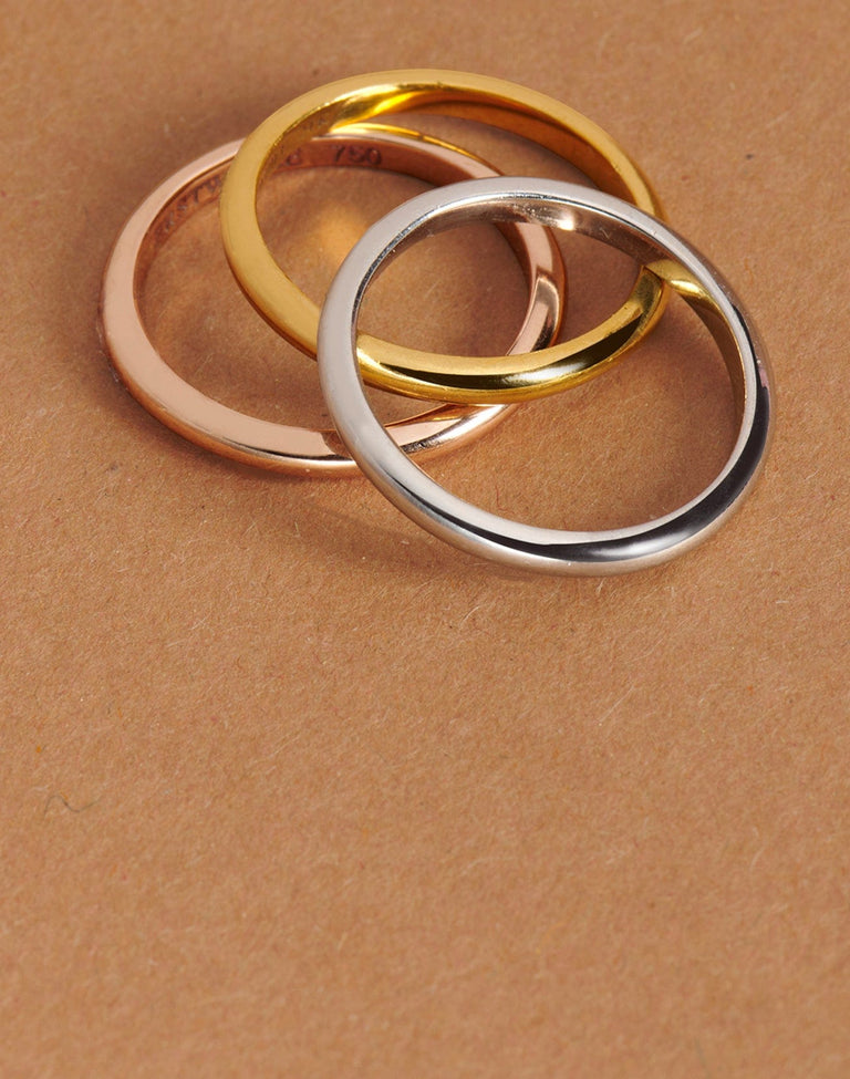 three classic plain wedding bands in platinum, gold and rose gold